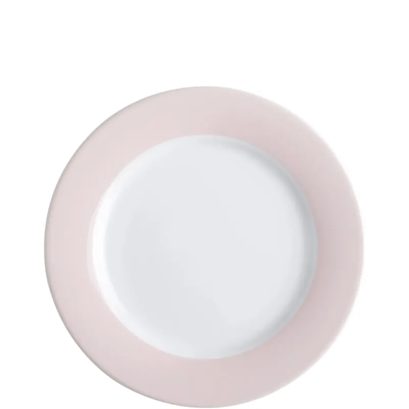 Ein runder, flacher Teller mit einem weißen Innenteil und einem zart rosa Rand. Der Teller hat eine glatte Oberfläche und ist in einer minimalistischen, eleganten Form gestaltet. Ideal für den Einsatz bei festlichen Anlässen oder im Alltag.