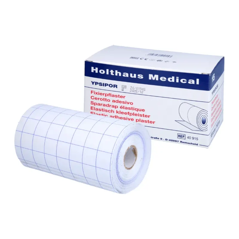 Eine Rolle Holthaus Medical Fixierpflaster mit Gittermuster liegt vor der Schachtel mit der Aufschrift „Holthaus Ypsidor“. Die mehrsprachige Beschreibung auf der Verpackung unterstreicht die vielseitigen Anwendungsmöglichkeiten.